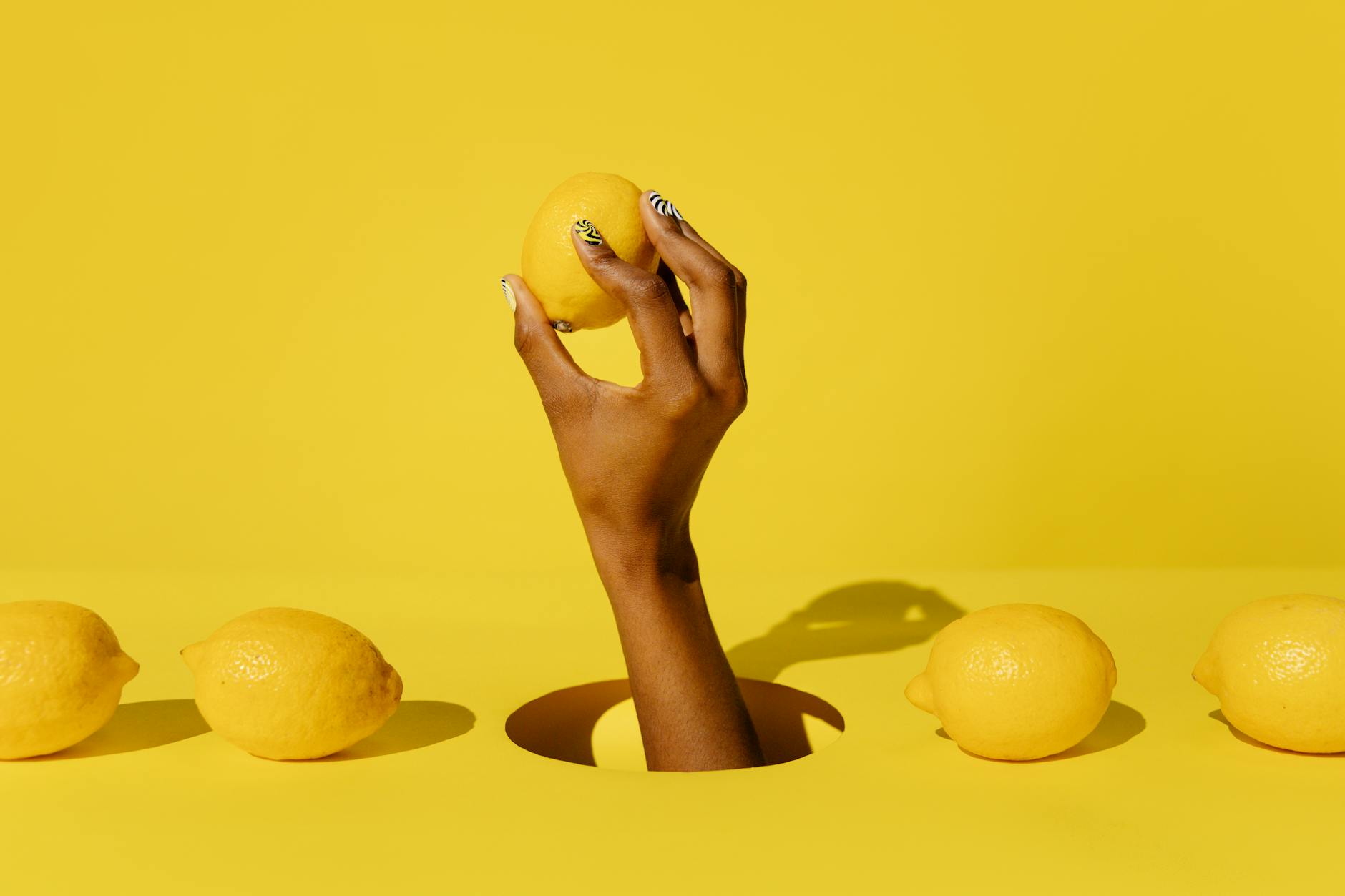 Ripe lemons composed on a bright yellow background, symbolizing freshness and renewed sensation