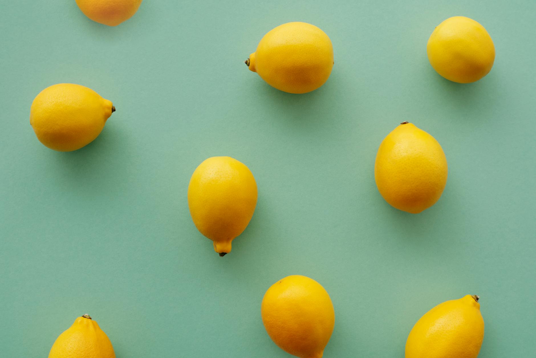Bright yellow lemons arranged on a pastel background, symbolizing the fresh start of pleasure after 50